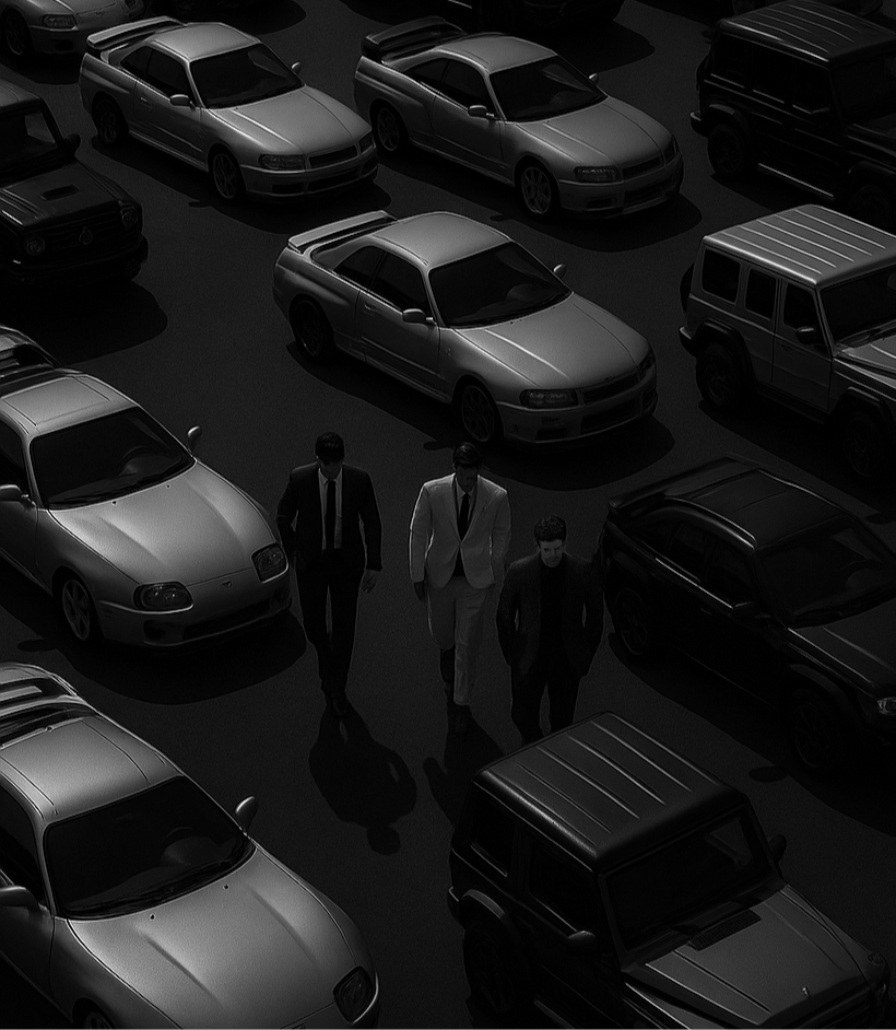 Three men in suits standing among parked cars in a dark setting